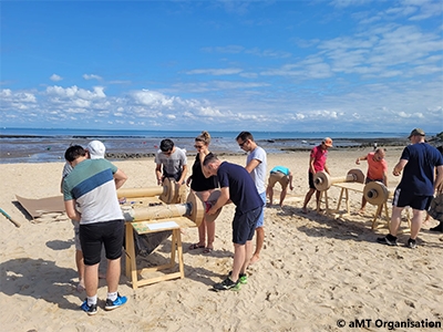 Team building construction de voitures en carton sur la plage