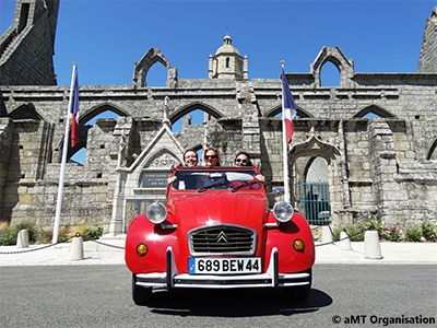 Equipe dans une 2CV rouge lors d'un team building